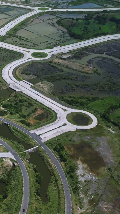 Elevated Interchange Featuring Intertwining Ramps And Lush Embankments Stock Footage 328018447