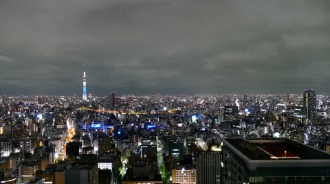Elevated motion timelapse of citylights and night clouds over the Tokyo sky. Stock Footage 65249947