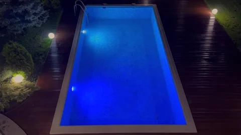 Elevated night view of illuminated backyard swimming pool Stock Footage 295368795