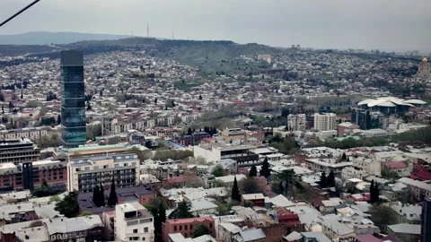 Elevated panoramic view of Tbilisi cityscape, highlighting modern skyscraper Vídeos de archivo 334612617