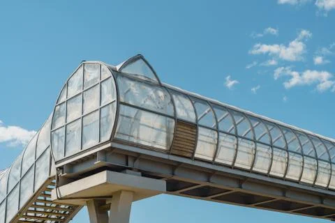 Elevated pedestrian crossing over the freeway, white carbon fiber, arched tunnel Stock Photos