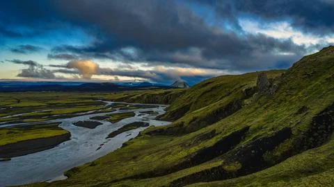 Elevated perspective of glacial braided river system cutting through moss-cov Stock Photos