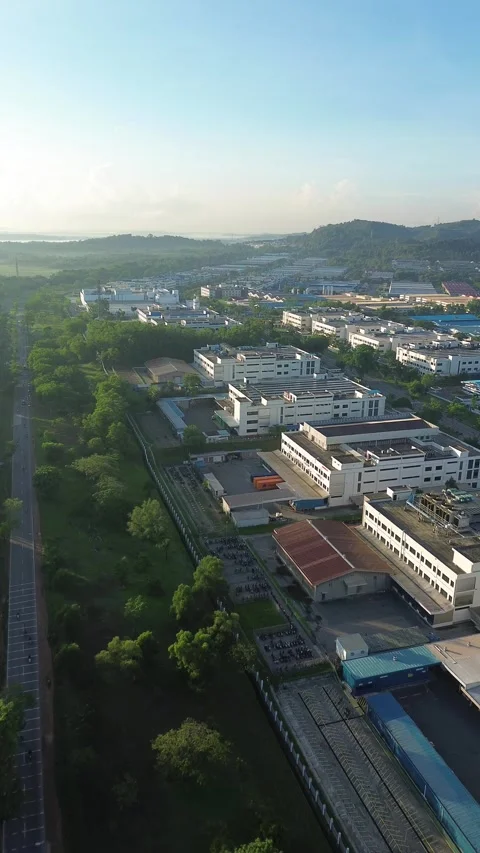 Elevated perspective reveals a dynamic industrial park amidst verdant lands.. Stock Footage 337280318