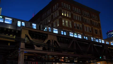 Elevated Public train passing between buildings in downtown Chicago at Stock-Footage 304395805