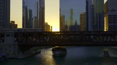 Elevated rail track bridge with subway train moving and tourist boat under the Stock Footage 319048172