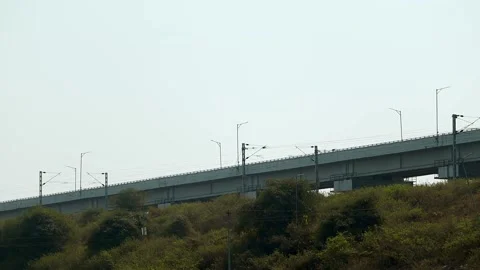 Elevated railway bridge passing over green hillside landscape Stock Footage 330707179
