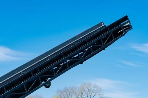 Elevated ramp structure against clear blue sky in outdoor setting Stock Photos