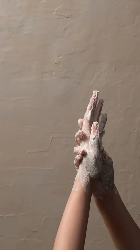 Elevated shot captures a woman's hands gently covered in exfoliating scrub .. Stock Footage 304213091