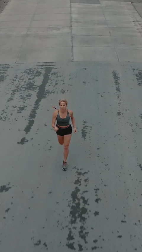 Elevated shot of female runner closing in toward the camera Stock Footage 340046895