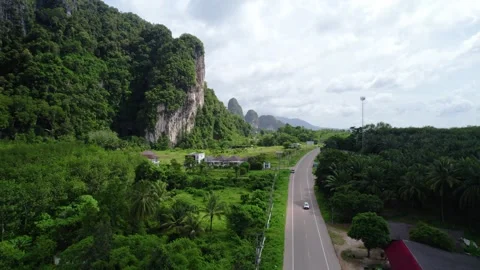 Elevated Shot of Road Through Green Terrain with Limestone Karsts in Distance Vídeos de archivo 332609748