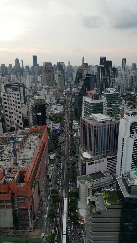 Elevated Skytrain Moving Through Bangkok, Thailand Cityscape with Traffic Stock Footage 333598442