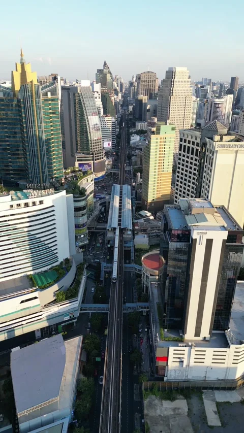 Elevated Skytrain Traveling Through Downtown Bangkok, Thailand Cityscape Stock Footage 335587554