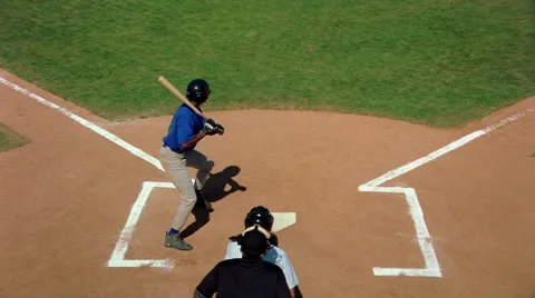 Elevated slow-motion rear view of batter hitting a line drive toward third base Stock Footage 59534336