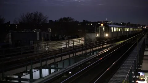 Elevated Subway Train arriving in Station at night. New York City Subway Stock Footage 200000105