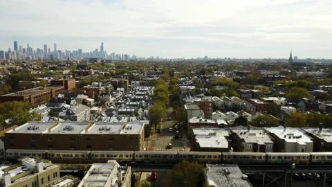 Elevated Subway Train Crossing Road. Chicago Skyline in Background Stock Footage 153122915