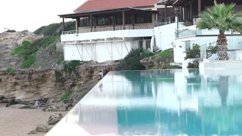 Elevated swimming pool right on the seashore Stock Footage 256975084