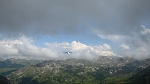 Elevated time lapse of clouds moving over an amazing alpine landscape Stock Footage 255398787
