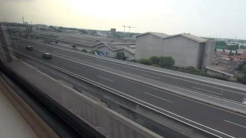 Elevated toll road seen from the window of a high-speed train Stock Footage 309974097
