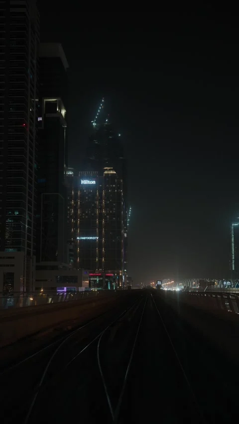 Elevated tracks curve beyond Hilton Al Habtoor City in Dubai UAE 库存影片 344916043