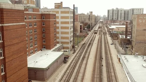 Elevated train coming down tracks in an urban area Stock-Footage 98720552