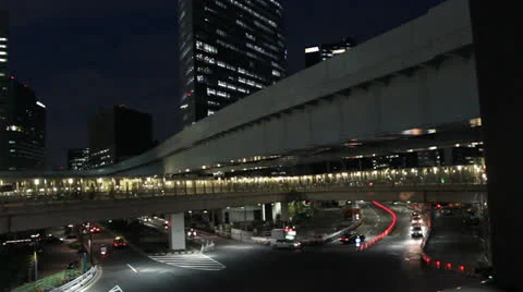 Elevated train passes by at night in Tokyo Stock Footage 25821997