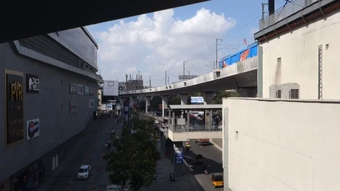 Elevated train passing a metro station next to a mall in Hyderabad Stock Footage 98722772