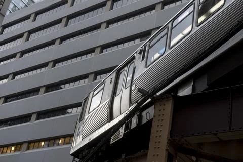 Elevated train passing a modern office building in chicago Stock Photos