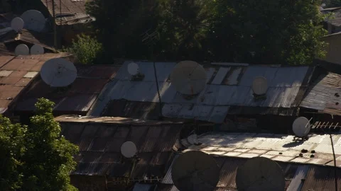 Elevated view of antenna on rusty corrugated house roof Stock Footage 107016120