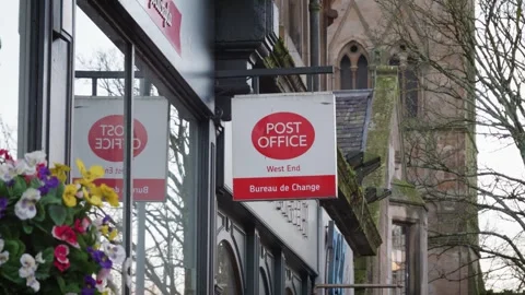 Elevated View of a British Post Office Sign with Bureau De Change in Glasgow, UK Stock Footage 261330381