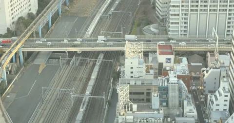Elevated view of busy commuting traffic and trains in Tokyo. Stock Footage 61645367