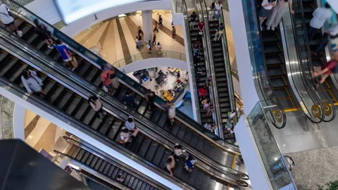 Elevated view of a busy mall interior with multiple escalators and shoppers Stock Footage 275267452
