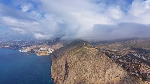 Elevated view of Calpe, Spain, showcasing the dramatic rocky Ifach headland Video stock 336742328