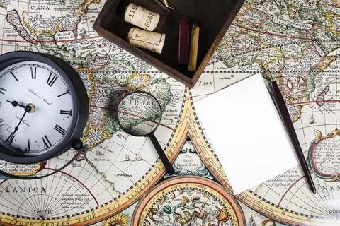 Elevated view clock magnifying glass colorful ancient map Stock Photos