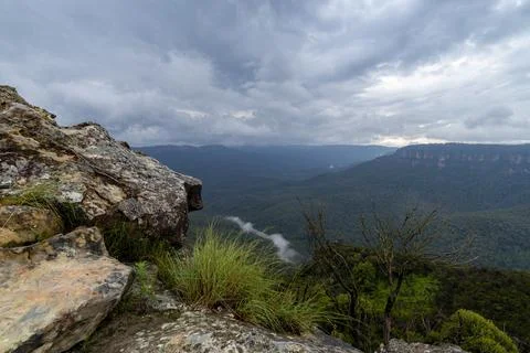 Elevated view of deep rugged valley and rolling hills from a rocky cliff edge Stock Photos