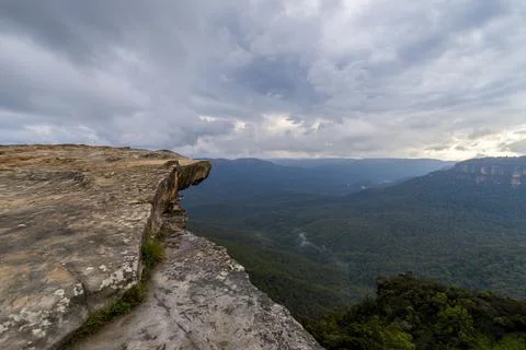 Elevated view of deep rugged valley and rolling hills from a rocky cliff edge Stock Photos