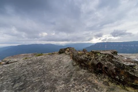Elevated view of deep rugged valley and rolling hills from a rocky cliff edge Stock Photos