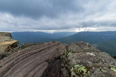 Elevated view of deep rugged valley and rolling hills from a rocky cliff edge Stock Photos