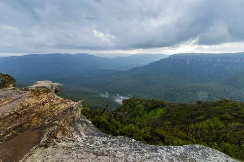Elevated view of deep rugged valley and rolling hills from a rocky cliff edge Stock Photos