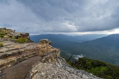 Elevated view of deep rugged valley and rolling hills from a rocky cliff edge Stock Photos