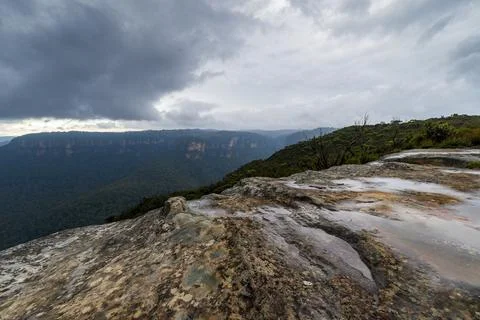 Elevated view of deep rugged valley and rolling hills from a rocky cliff edge Stock Photos