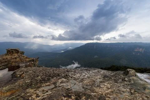 Elevated view of deep rugged valley and rolling hills from a rocky cliff edge Stock Photos