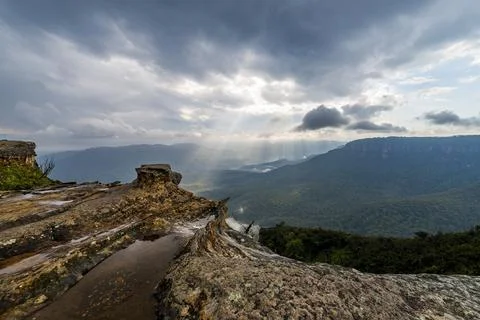 Elevated view of deep rugged valley and rolling hills from a rocky cliff edge Stock Photos