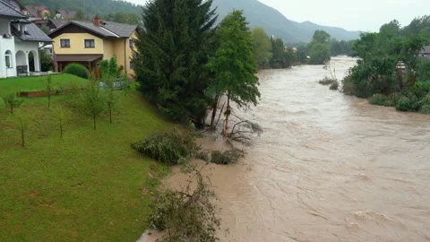 Elevated view of a destructive river with raging dirty brown water Stock Footage 247395643