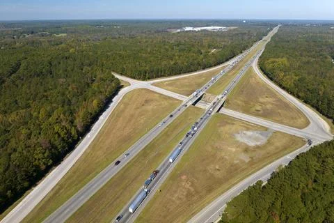 Elevated view of freeway exit junction over road lanes with fast moving traffic Stock Photos