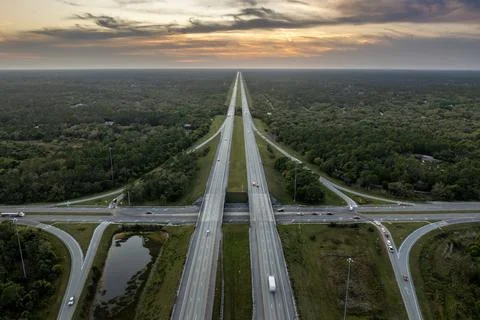 Elevated view of freeway exit junction over road lanes with fast moving tra.. Stock Photos
