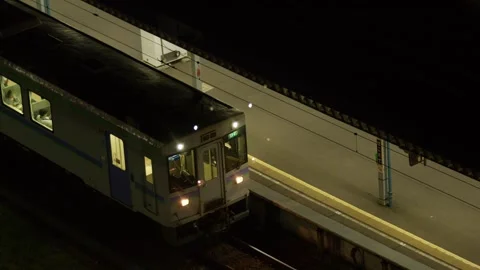 Elevated view of KiHa 40 pulling away at night, Hakodate, Japan, 2026.09.10. Stock Footage 345428161