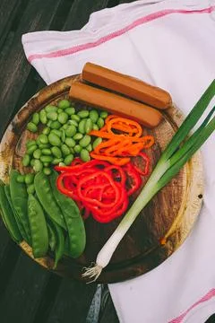 Elevated view of lima beans, spring onion, tofu, mangetout and peppers on a Stock Photos