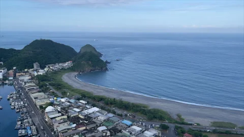 Elevated View Of A Long Curved Beach Edging A Calm Bay And Coastal Town Video stock 342824645