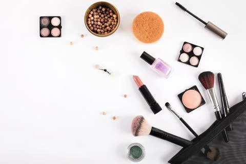 Elevated view makeup brushes cosmetics white backdrop Stock Photos