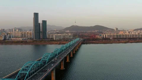 Elevated View of Modern Bridge Spanning River with City Skyline Vídeos de archivo 311103718